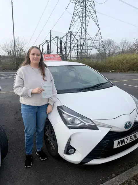 A Learners' Club pupil holding their driving test pass certificate